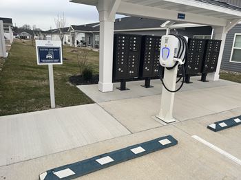 an electric charging station in front of the mailboxes